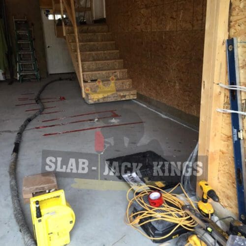 concrete garage floor lift before image